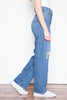 This jean has an ultra-high rise with a classic medium blue washthat features two rips over the lower thighs. 